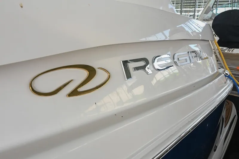Slide: The Image of 2009 Regal 3060 Window Express boat logo on white hull. - 4