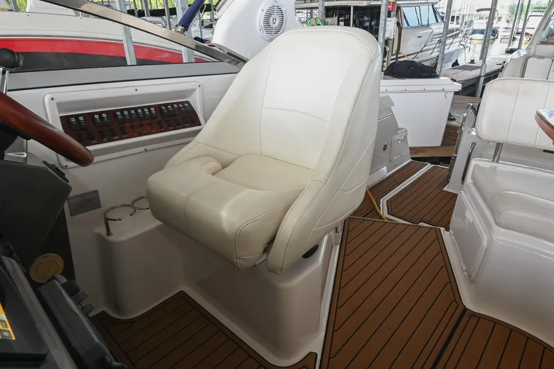 Slide: The Image of Captain's seat on 2009 Regal 3060 Window Express boat, featuring sleek design and control panel. - 23