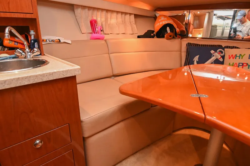 Slide: The Image of Interior of 2009 Regal 3060 Window Express yacht with cozy seating and wooden table. - 38