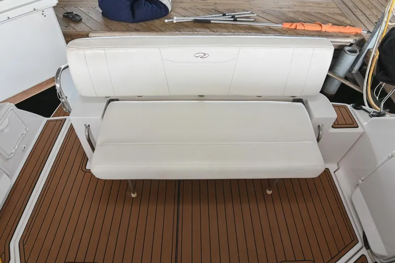 Slide: The Image of 2009 Regal 3060 Window Express boat interior with white seating and wood flooring. - 10