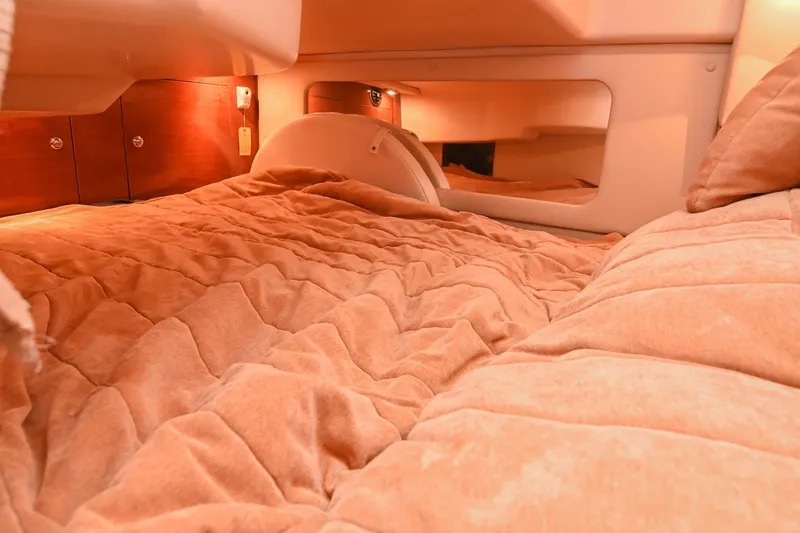 Slide: The Image of Interior cabin of 2009 Regal 3060 Window Express with cozy bedding and warm lighting. - 46
