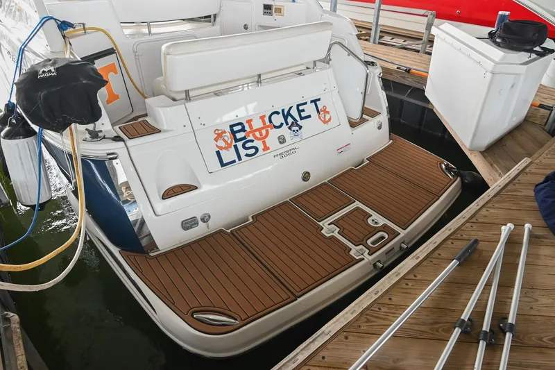 Slide: The Image of 2009 Regal 3060 Window Express boat docked with "Bucket List" sign on the back. - 6