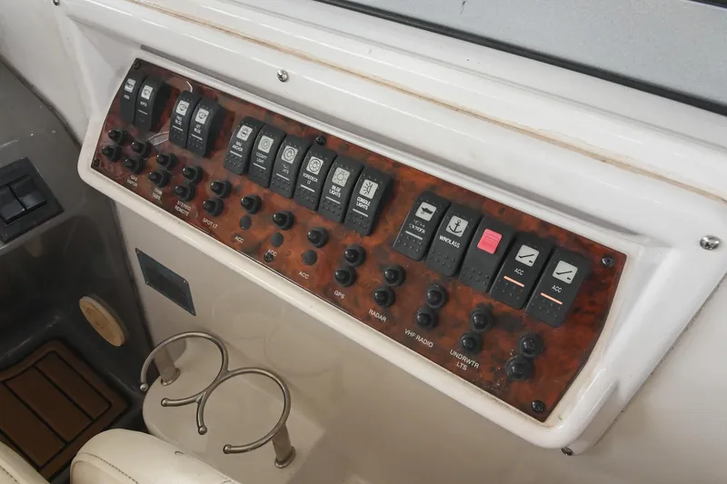 Slide: The Image of Control panel of a 2009 Regal 3060 Window Express boat with various switches. - 21
