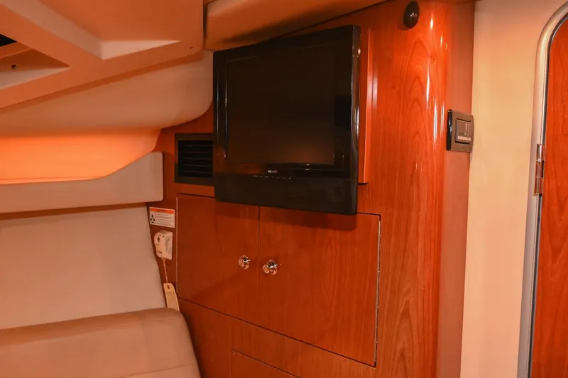 Slide: The Image of Interior of 2009 Regal 3060 Window Express yacht with mounted TV and wooden cabinetry. - 41