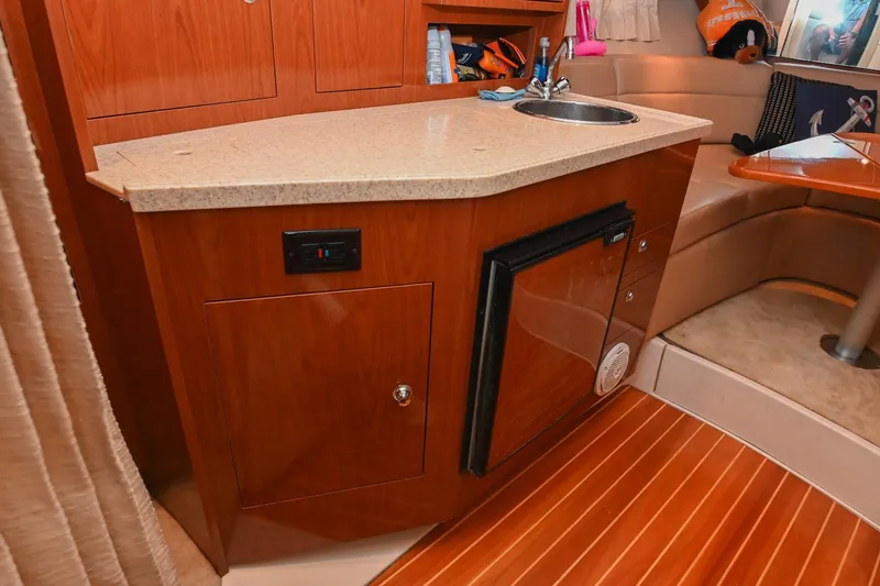 Slide: The Image of 2009 Regal 3060 Window Express yacht interior with kitchenette and seating area. - 32