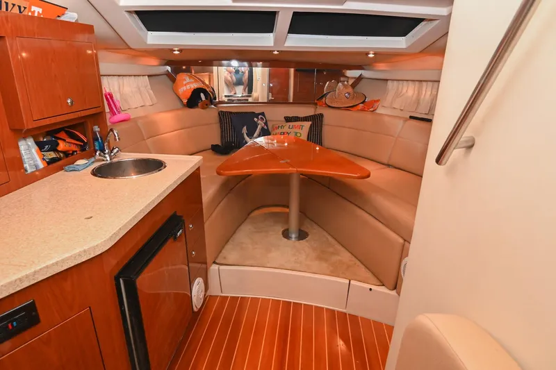 Slide: The Image of Luxurious interior of 2009 Regal 3060 Window Express yacht with kitchenette and seating area. - 31