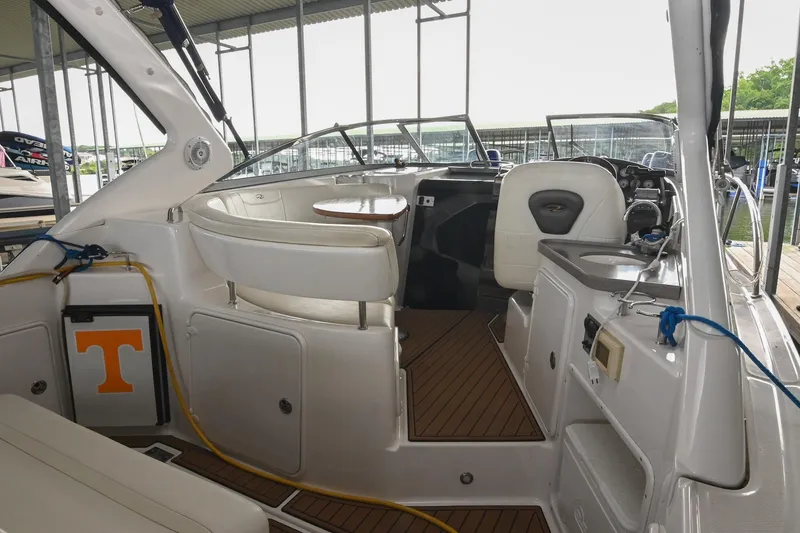Slide: The Image of 2009 Regal 3060 Window Express boat interior with seating and helm in marina. - 7