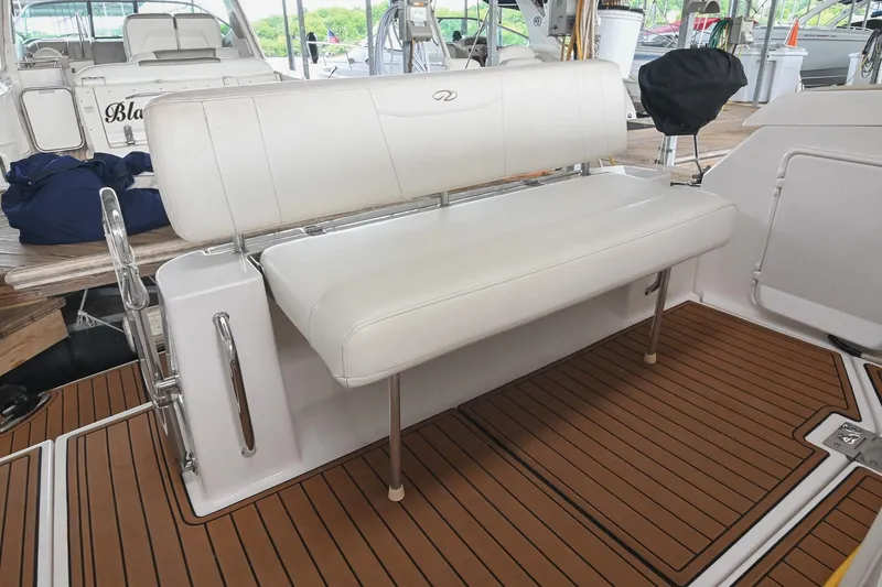 Slide: The Image of 2009 Regal 3060 Window Express boat interior with white seating and wood-patterned flooring. - 9