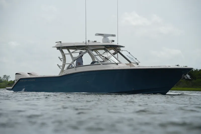 Slide: The Image of 2018 Grady-White Freedom 325 boat on calm water, side view. - 10
