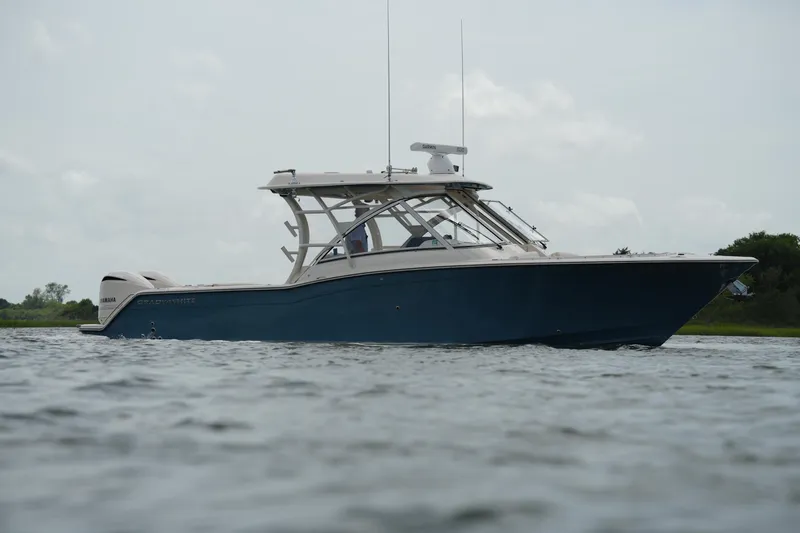 Slide: The Image of 2018 Grady-White Freedom 325 boat on calm water, side view. - 11