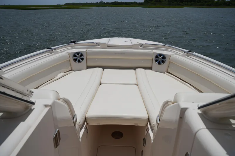Slide: The Image of 2018 Grady-White Freedom 325 boat interior with cushioned seating on open water. - 51
