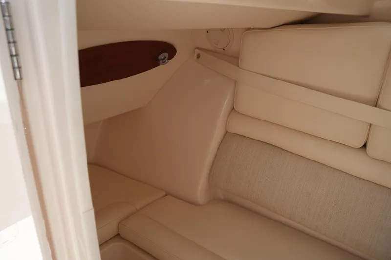 Slide: The Image of Interior cabin of 2018 Grady-White Freedom 325 boat, featuring beige seating. - 48