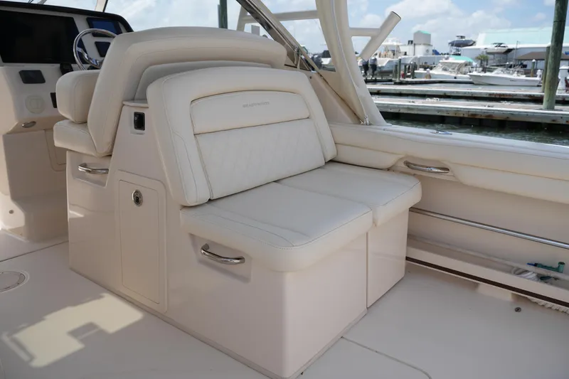 Slide: The Image of 2018 Grady-White Freedom 325 boat interior with luxurious seating and helm. - 26
