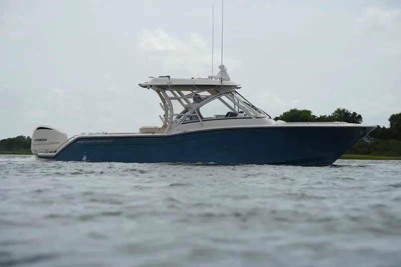 Slide: The Image of 2018 Grady-White Freedom 325 boat on water, side view, with Yamaha engine. - 12