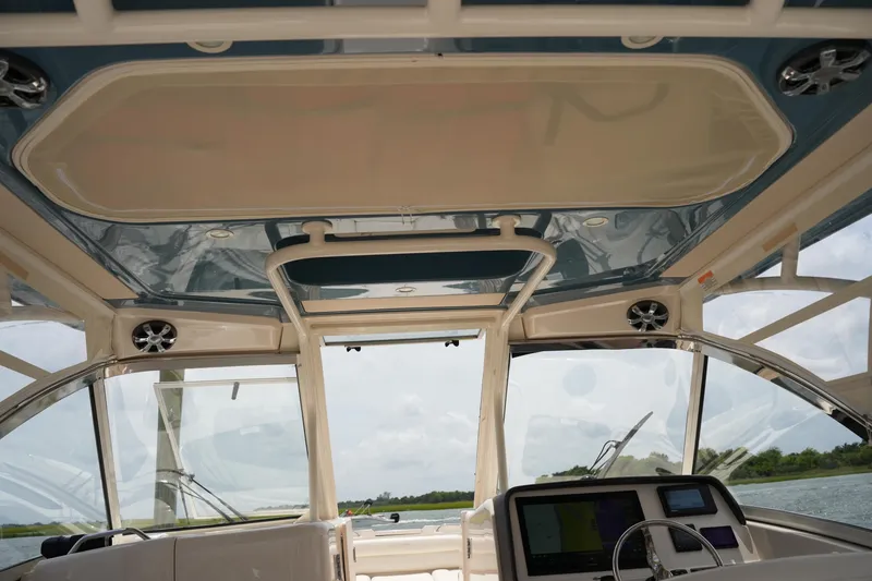 Slide: The Image of Interior view of 2018 Grady-White Freedom 325 boat, showcasing helm and overhead design. - 43