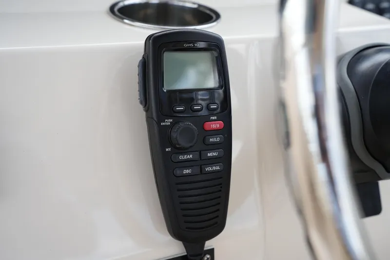 Slide: The Image of Close-up of a marine radio on a 2018 Grady-White Freedom 325 boat dashboard. - 41