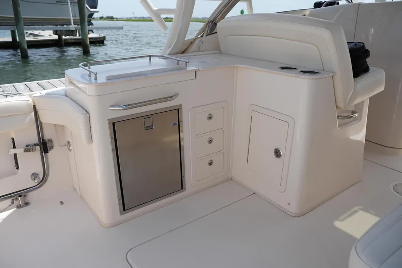 Slide: The Image of 2018 Grady-White Freedom 325 boat interior with storage and seating area. - 24