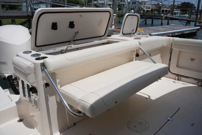 Slide: The Image of 2018 Grady-White Freedom 325 boat interior with foldable seating and storage compartments. - 18