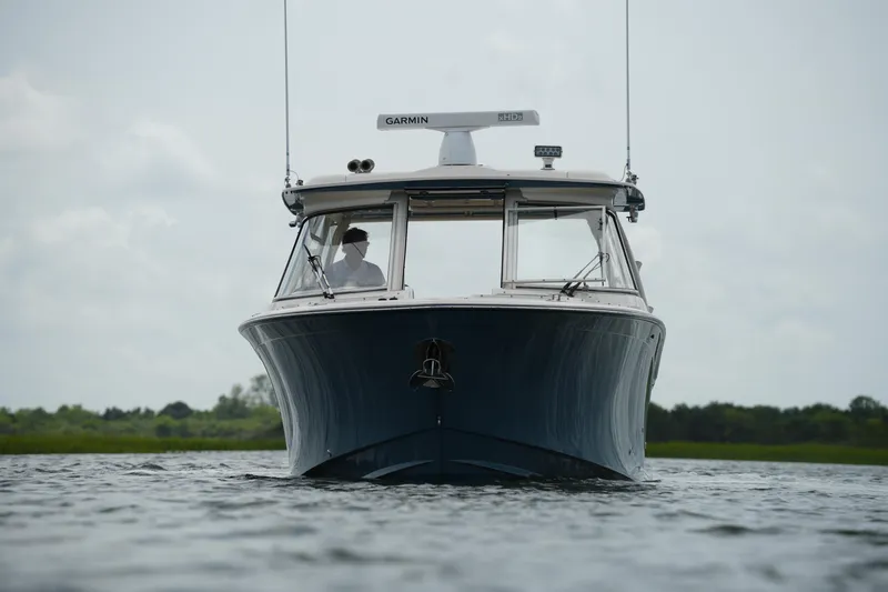 Slide: The Image of 2018 Grady-White Freedom 325 boat on water, front view with Garmin equipment. - 6