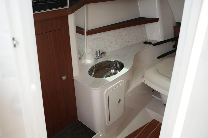 Slide: The Image of Interior of 2018 Grady-White Freedom 325 boat featuring a compact sink and seating area. - 44