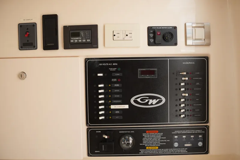 Slide: The Image of Control panel of a 2018 Grady-White Freedom 325 boat, featuring various switches and alerts. - 49