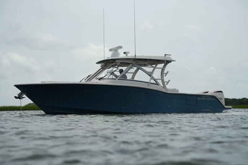Slide: The Image of 2018 Grady-White Freedom 325 boat on calm water, side view. - 2