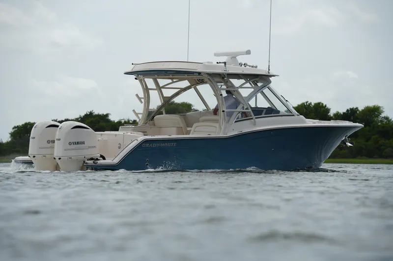 Slide: The Image of 2018 Grady-White Freedom 325 boat with twin Yamaha engines on water. - 13