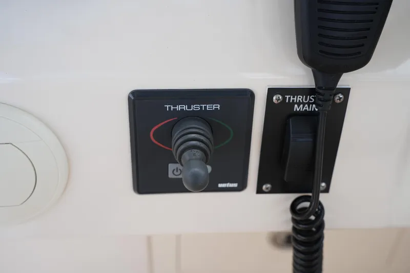 Slide: The Image of Control panel of a 2018 Grady-White Freedom 325 boat featuring thruster controls. - 42