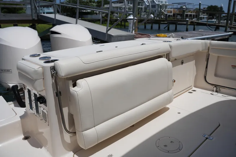 Slide: The Image of 2018 Grady-White Freedom 325 boat interior with foldable seating and dual outboard engines. - 17