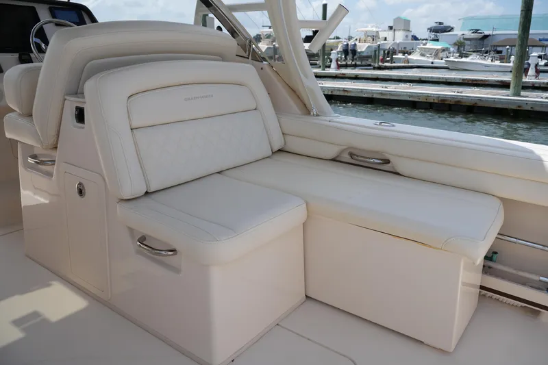 Slide: The Image of 2018 Grady-White Freedom 325 boat interior with luxurious white seating. - 27