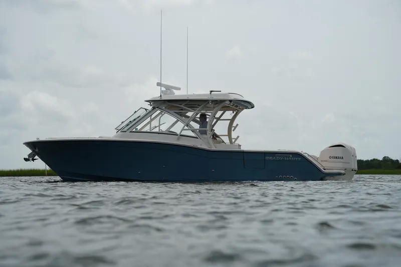 The Image of 2018 Grady-White Freedom 325 boat on water, side view, overcast sky. - 0