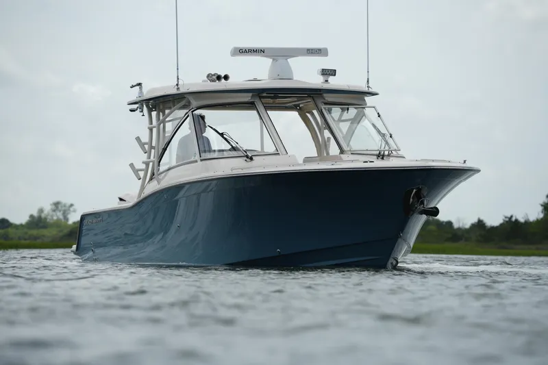 Slide: The Image of 2018 Grady-White Freedom 325 boat on water, showcasing sleek design and advanced features. - 8
