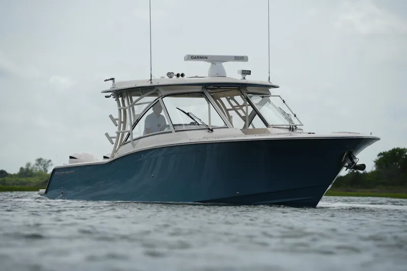 Slide: The Image of 2018 Grady-White Freedom 325 boat on calm water, showcasing sleek design and modern features. - 9