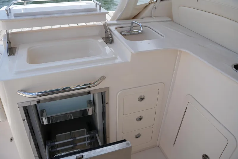 Slide: The Image of 2018 Grady-White Freedom 325 boat interior with sink and storage compartments. - 25