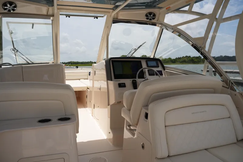 Slide: The Image of 2018 Grady-White Freedom 325 boat interior with helm and seating. - 28