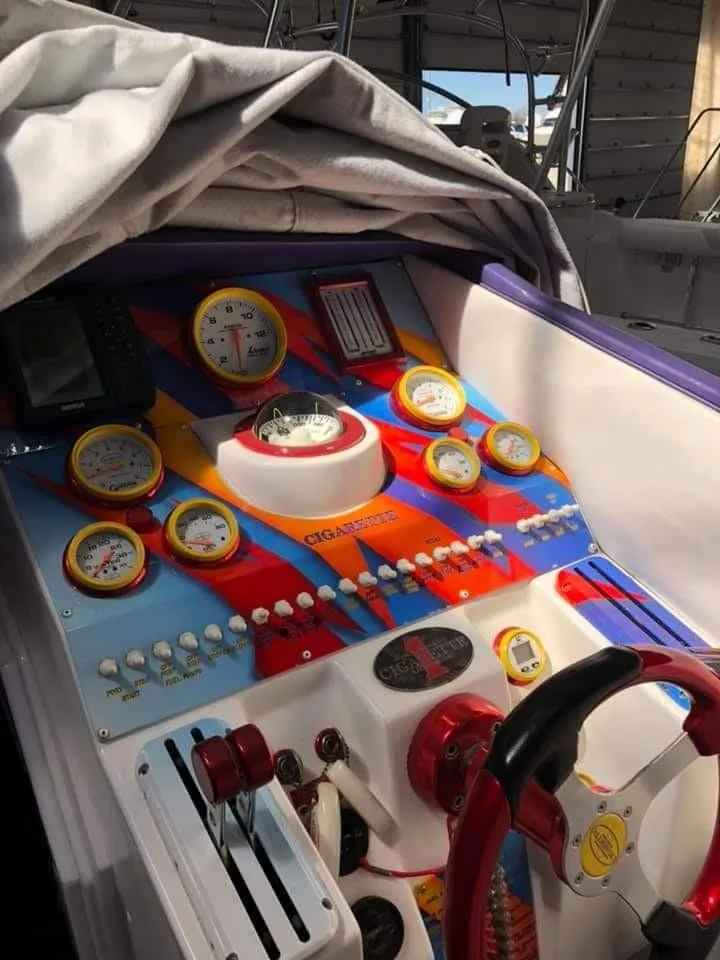 Slide: The Image of The cockpit of a 2003 Cigarette 38' Top Gun features colorful instruments and controls. - 10