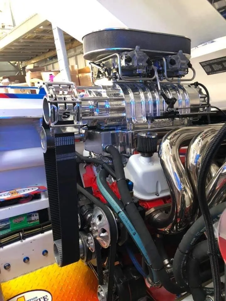 Slide: The Image of Close-up of a powerful boat engine with shiny metal parts and complex hoses. - 11