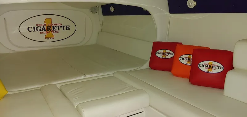 Slide: The Image of Interior of a 2003 Cigarette 38' Top Gun boat with white upholstery and branded cushions. - 20