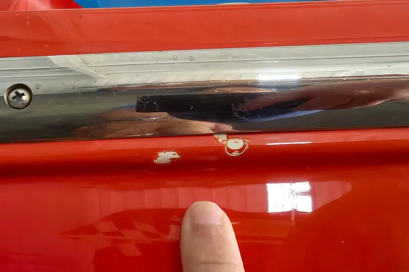 Slide: The Image of Close-up of a 2003 Cigarette 38' Top Gun boat with red paint chip. - 31