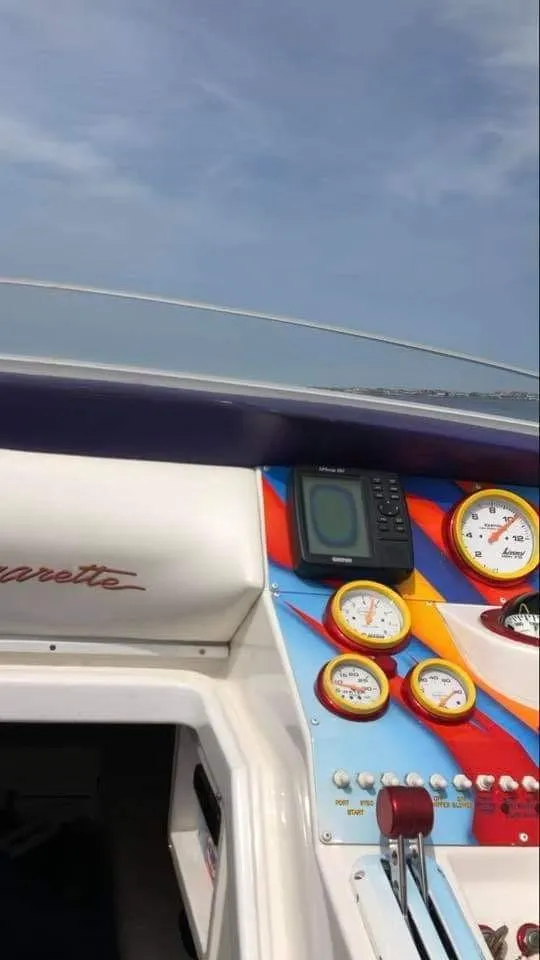 Slide: The Image of The cockpit of a 2003 Cigarette 38' Top Gun with colorful gauges and a GPS device. - 7