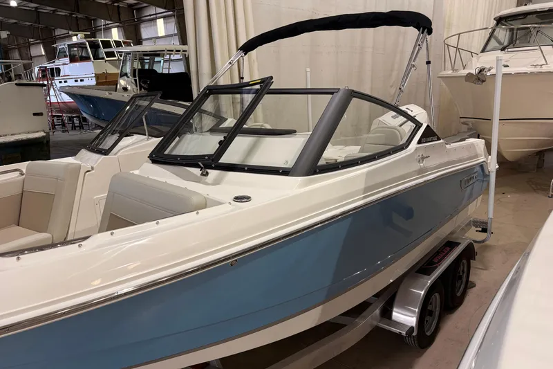 The Image of 2026 Boston Whaler 210 Vantage boat in showroom, featuring sleek design and blue accents. - 0