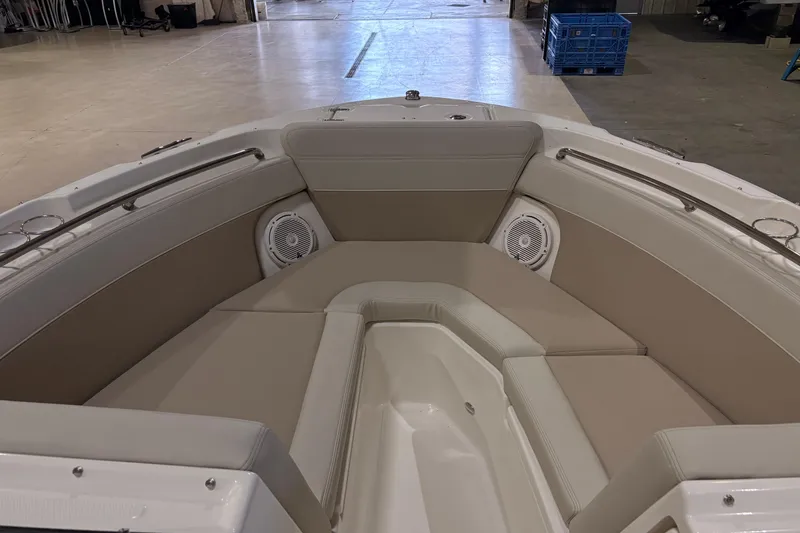 Slide: The Image of 2026 Boston Whaler 210 Vantage boat interior with beige seating and speakers. - 13