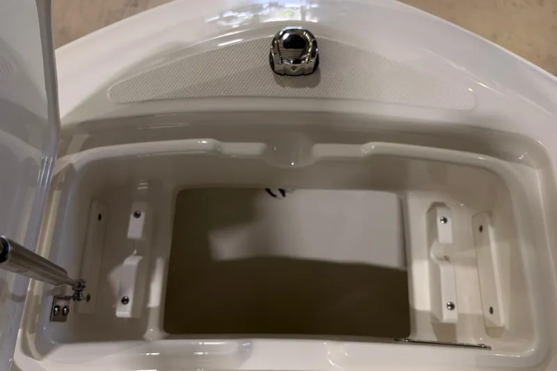 Slide: The Image of Open storage compartment on a 2026 Boston Whaler 210 Vantage boat. - 14