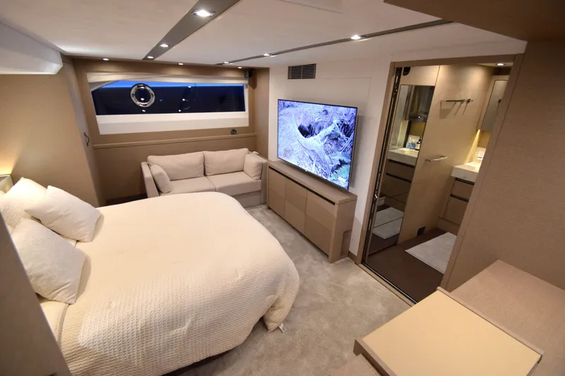 Slide: The Image of Luxurious cabin with a double bed, sofa, and large TV. Adjacent bathroom with modern amenities. - 41