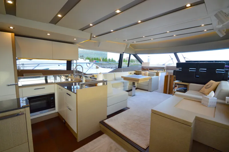 Slide: The Image of Interior of a 2017 Prestige 630 yacht featuring a modern kitchen and cozy living area. - 12