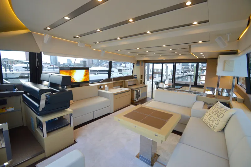 Slide: The Image of Luxurious salon of a 2017 Prestige 630 yacht with modern furnishings and large windows. - 26