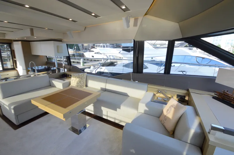 Slide: The Image of Luxurious salon of a 2017 Prestige 630 yacht with elegant sofas and large windows. - 31