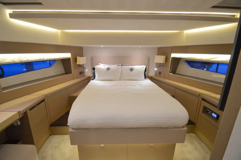 Slide: The Image of Luxurious cabin with a large bed, surrounded by elegant wood furnishings and soft lighting. - 3