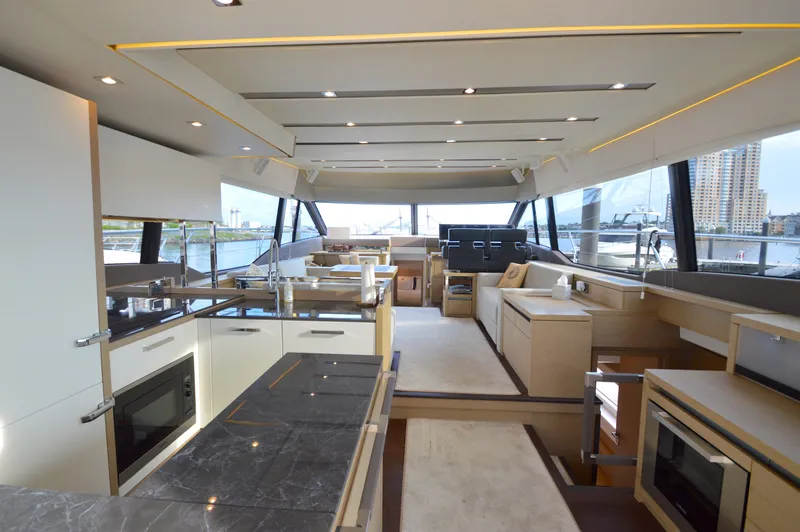 Slide: The Image of Interior of a luxury yacht with modern kitchen, dining area, and large windows. - 25