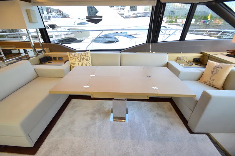 Slide: The Image of Interior of a 2017 Prestige 630 yacht featuring a stylish dining area and large windows. - 33
